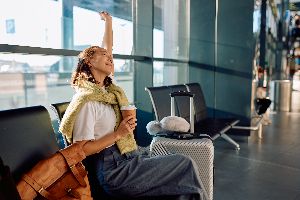 Woman sitting in the airport waiting to travel