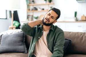 Someone with neck pain at home